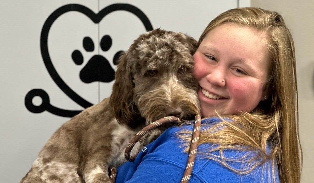 Hugging a dog patient at The Hometown Veterinarian